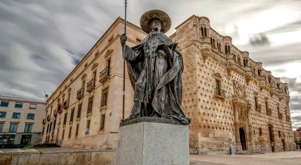 Pomnik w Guadalajara, Hiszpania, przed budynkiem z kamiennymi diamentami.