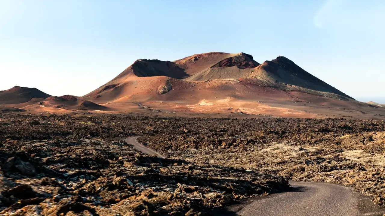 Droga przez wulkaniczny krajobraz na Lanzarote. Warto wiedzieć, że to miejsce zachwyca surowym pięknem.