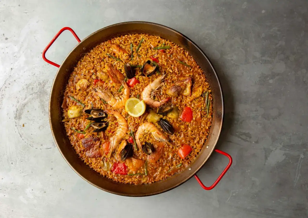 Pyszna paella z owocami morza, ryżem i warzywami, idealna na rodzinny obiad. Ten paella przepis oryginalny zachwyci każdego!