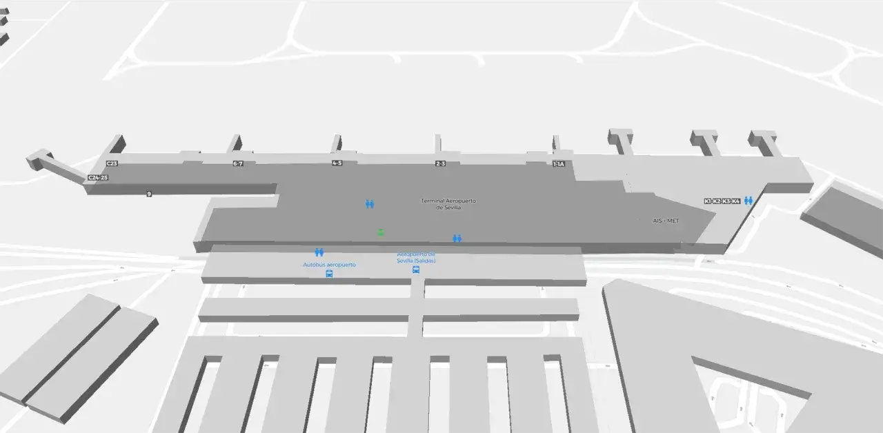 Widok z lotu ptaka na terminal lotniska Sewilla. Widoczne bramki, autobusy i oznaczenia.